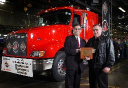 (L to R) Jordan Feiger, vice president and general manager, International's heavy vehicle centre presents a commemorative plaque and the keys of the 800,000th milestone vehicle, an International 9400i, to a long ime International customer Al McCully, president of Preferred Transportation Limited, today, Tuesday, October 7, 2003, in Chatham. (CANADA NEWSWIRE PHOTO/International Truck and Engine Corporation ) 